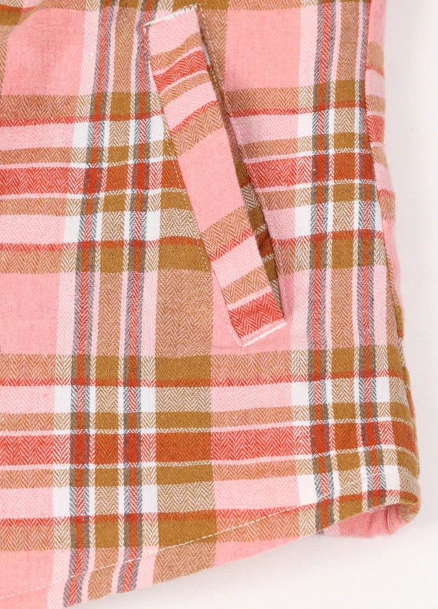 Close-up of women's peach pink sherpa-lined shirt jacket hand pocket