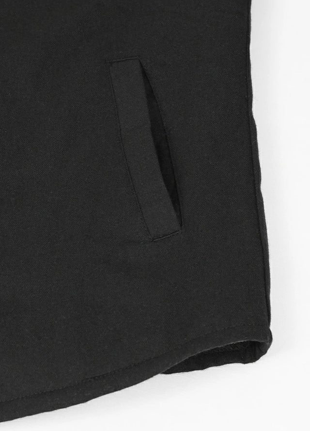 Close-up of women's solid black sherpa-lined shirt jacket hand pocket