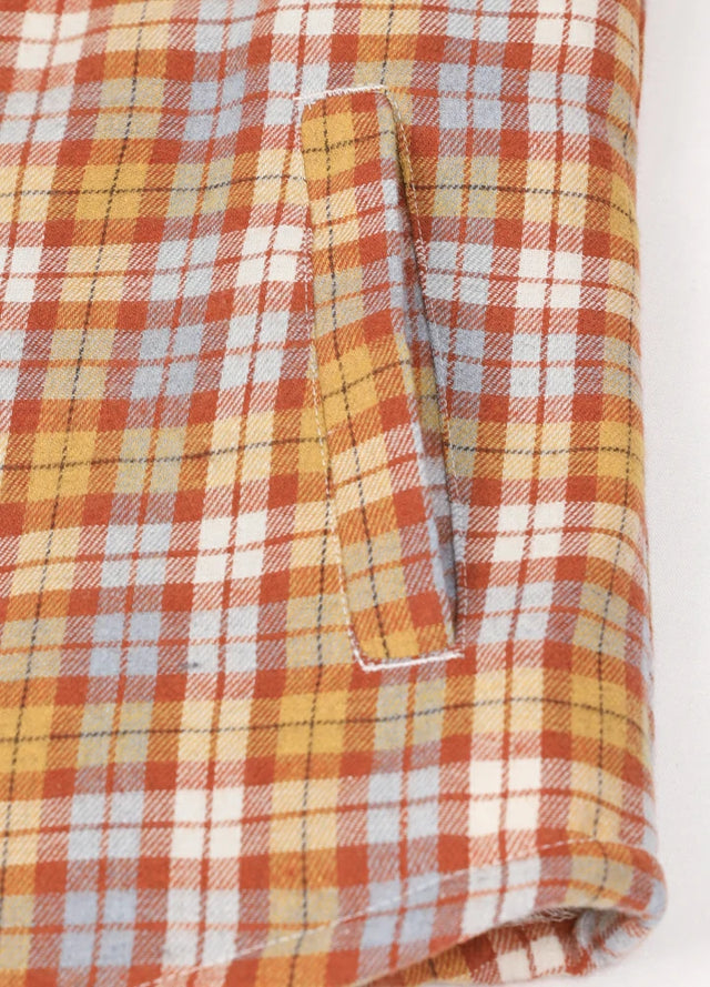 Close-up of women's orange sherpa-lined shirt jacket hand pocket