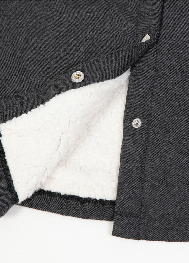 Zoomed-in view of the hem on a womens winter snap gray shirt jacket