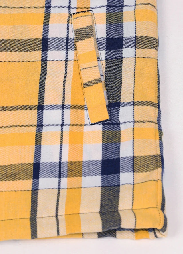 Close-up of the handpocket of a men's yellow and navy sherpa lined flannel jacket