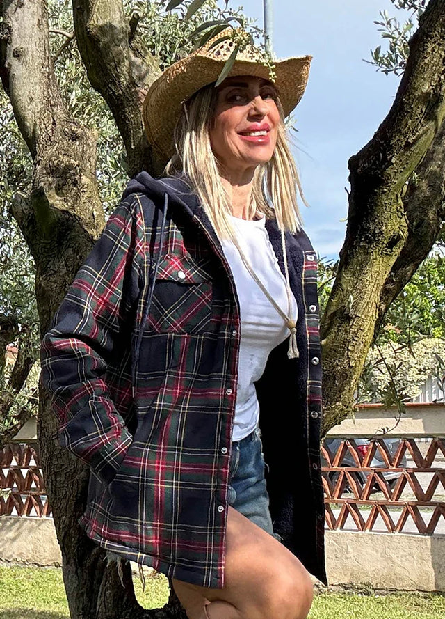 Side view of women in a navy red winter flannel jacket with fleece hood
