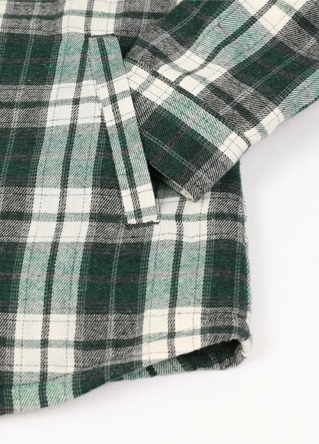 Close-up of womens sherpa-lined green flannel hooded hand pocket