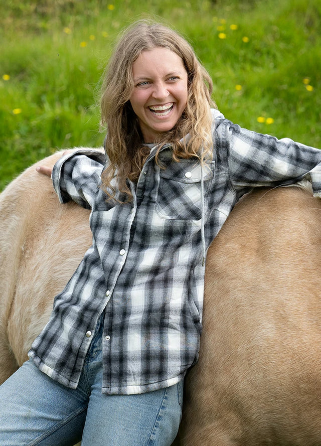 Women wearing a black white snap button flannel jacket with hood