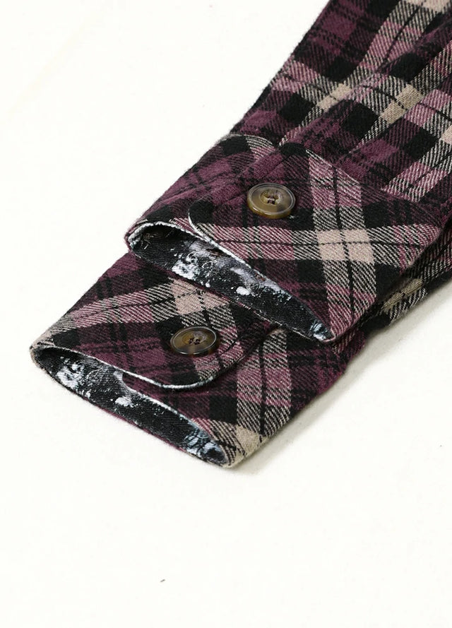 Cuff detail of men's dark brown plaid flannel shirt