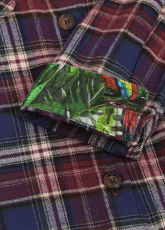 Close-up of the printed cuffs on a mens burgundy plaid flannel shirt