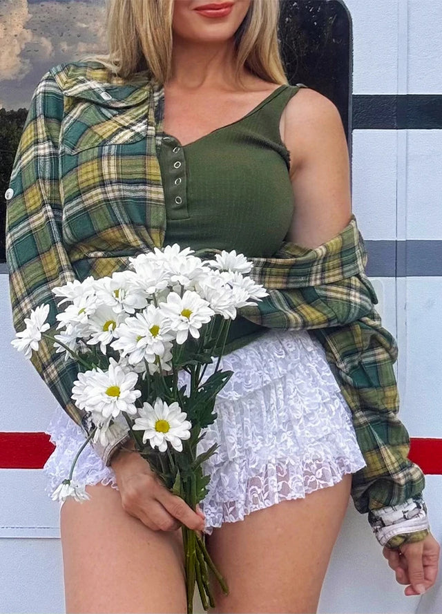 Side view of women in a printed forest green plaid flannel shirt
