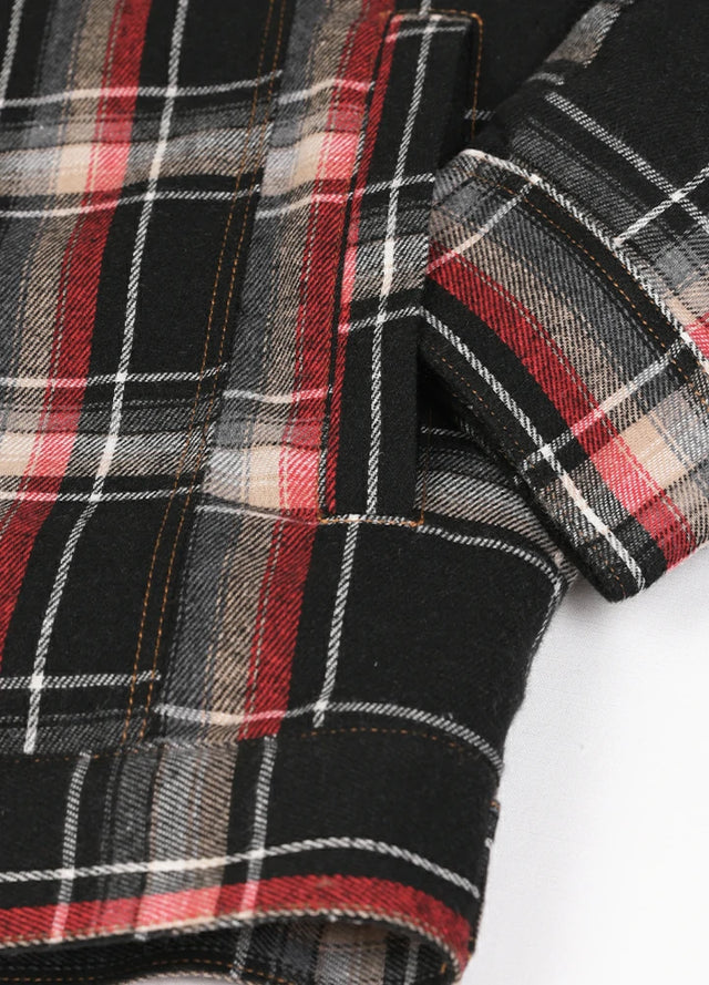 Detailed view of the hand pocket of the black red men's warm snap button up jacket