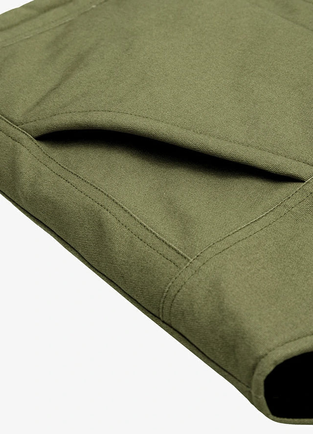 Close-up of the arctic-lined hand warmer pocket on men's green quilted canvas work vest