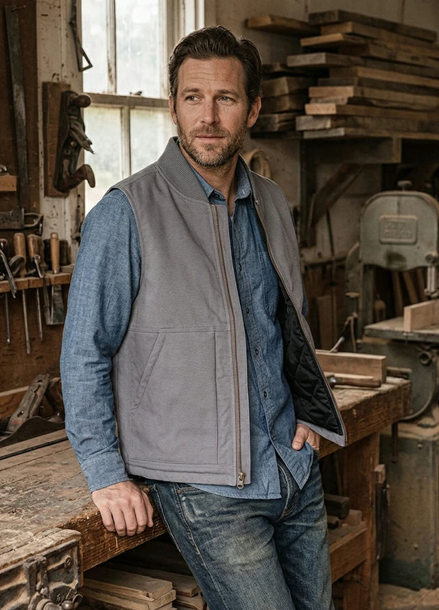 Lifestyle view of a man wearing grey men's arctic quilt lined washed rugged duck canvas vest-XR601Gr0M,XR601Gr0L,XR601Gr0XL,XR601Gr0XXL