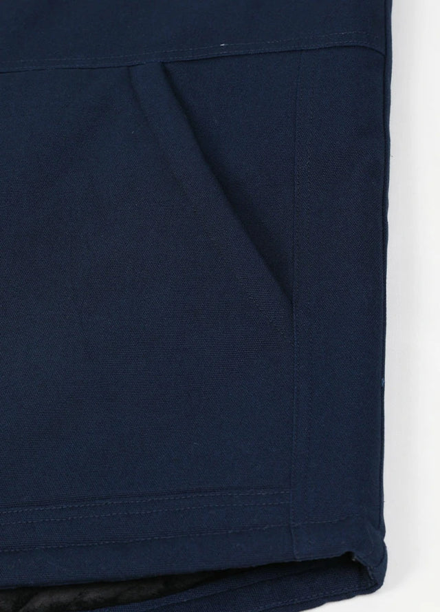 Close-up of the arctic-lined hand warmer pocket on men's quilted canvas work vest