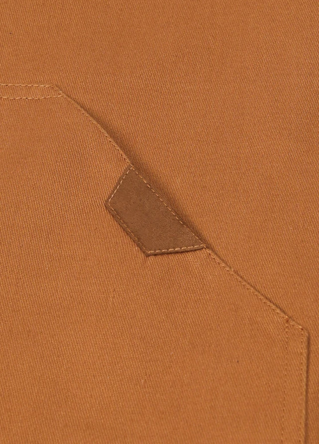 Detailed view of the hand pocket of the yellow brown men's quilted lined adventure outdoor vest