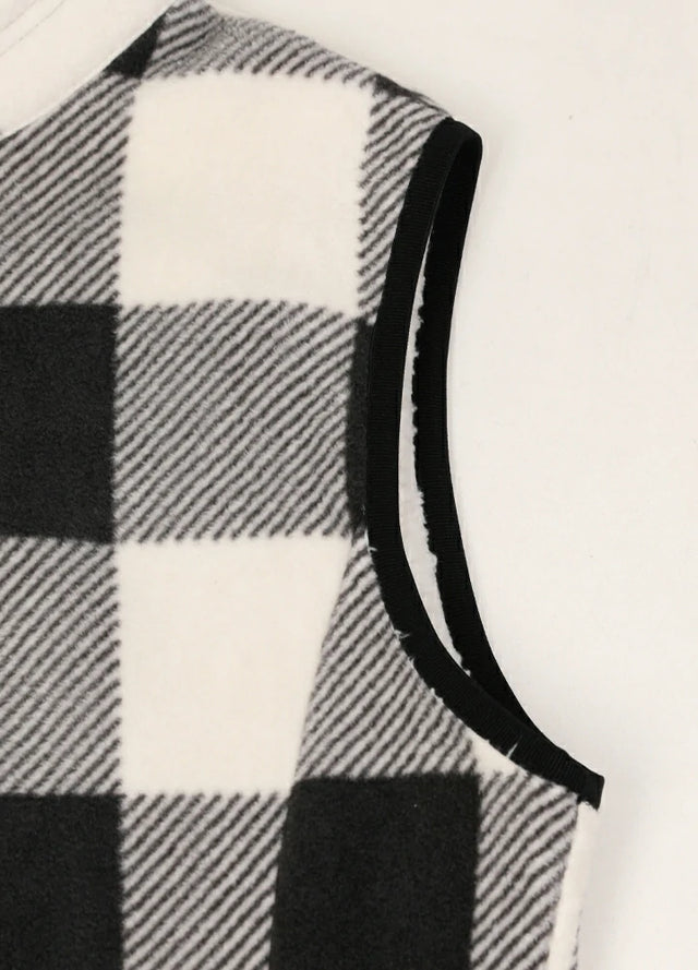 Close-up of women's warm sherpa-lined black white plaid fleece vest cuffs