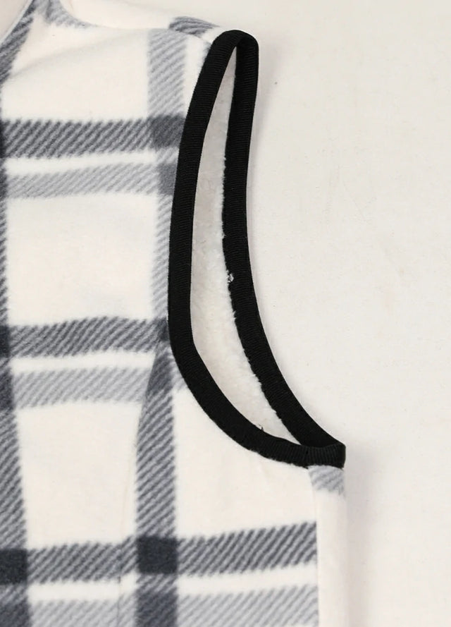 Close-up of women's warm sherpa-lined white plaid fleece vest cuffs