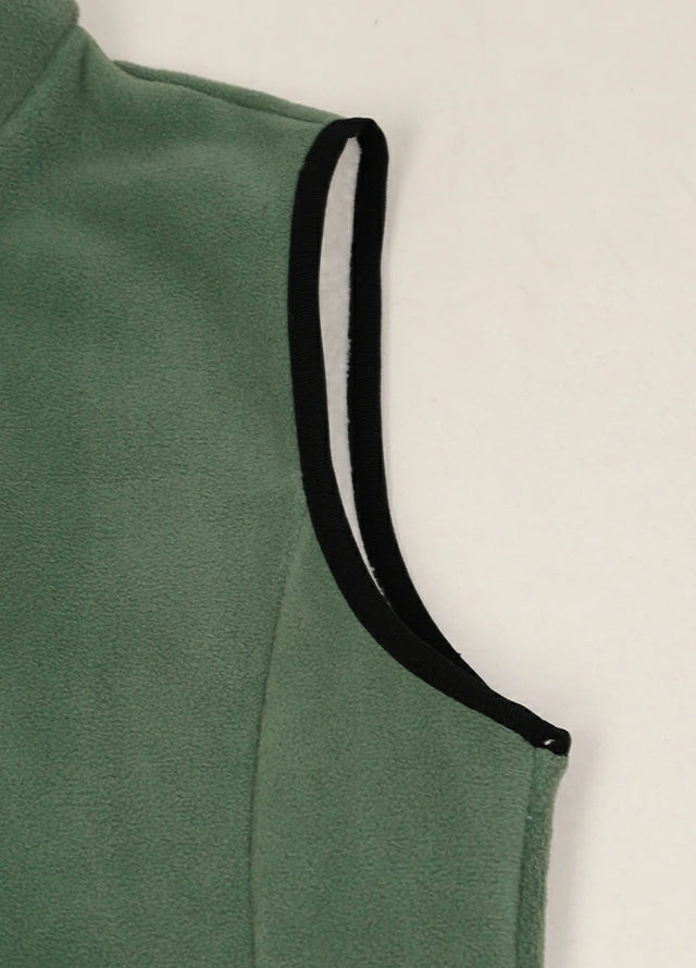 Close-up of women's warm sherpa-lined forest green fleece vest cuffs