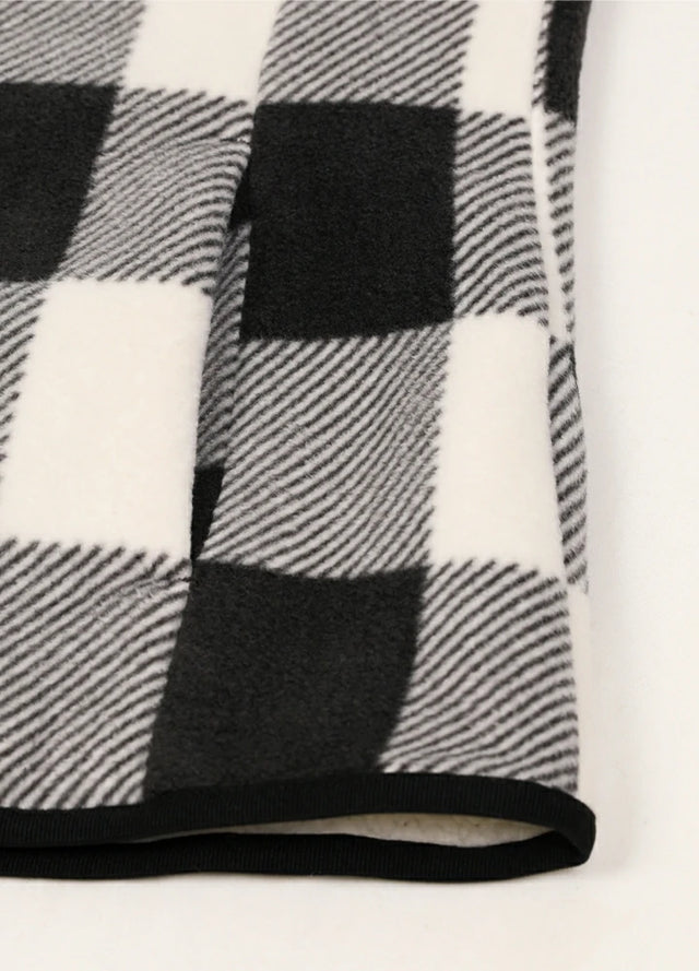 Detailed view of women's winter black white sweater fleece vest hand pocket