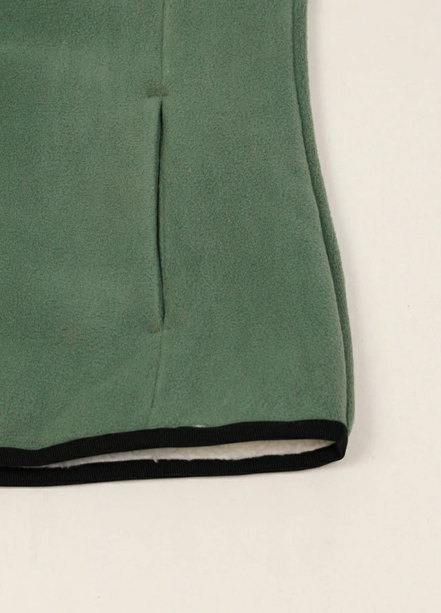 Detailed view of women's winter forest green sweater fleece vest hand pocket