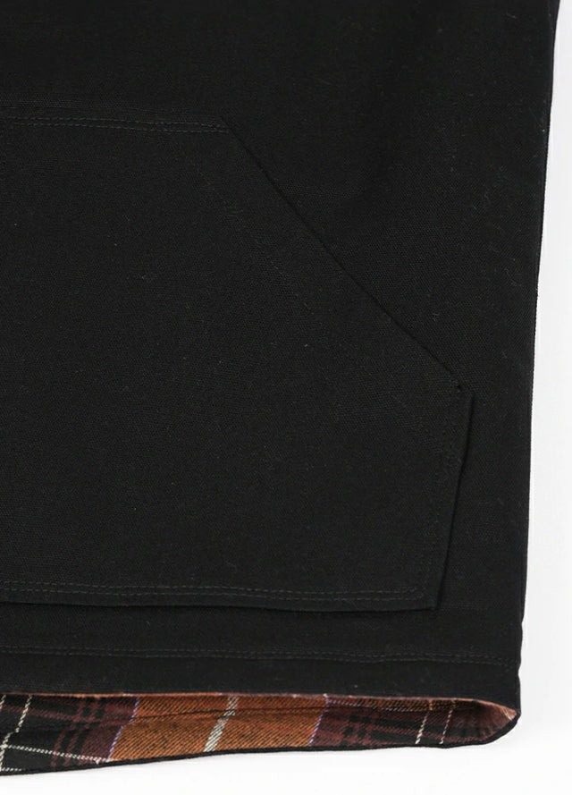 Close-up of the hand pocket of the black men's sherpa lined canvas vest