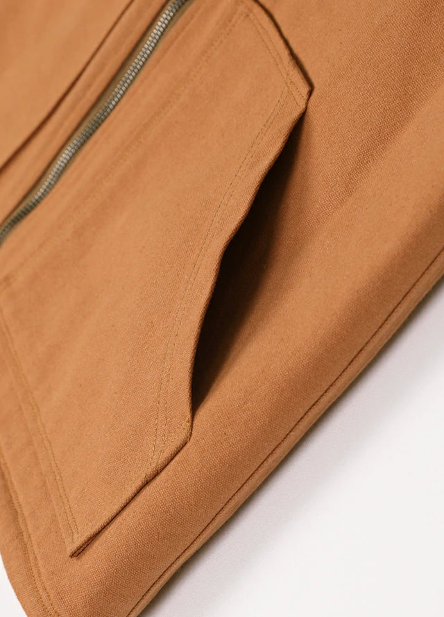 Close-up of the hand pocket of a brown men's durable sherpa lined canvas vest
