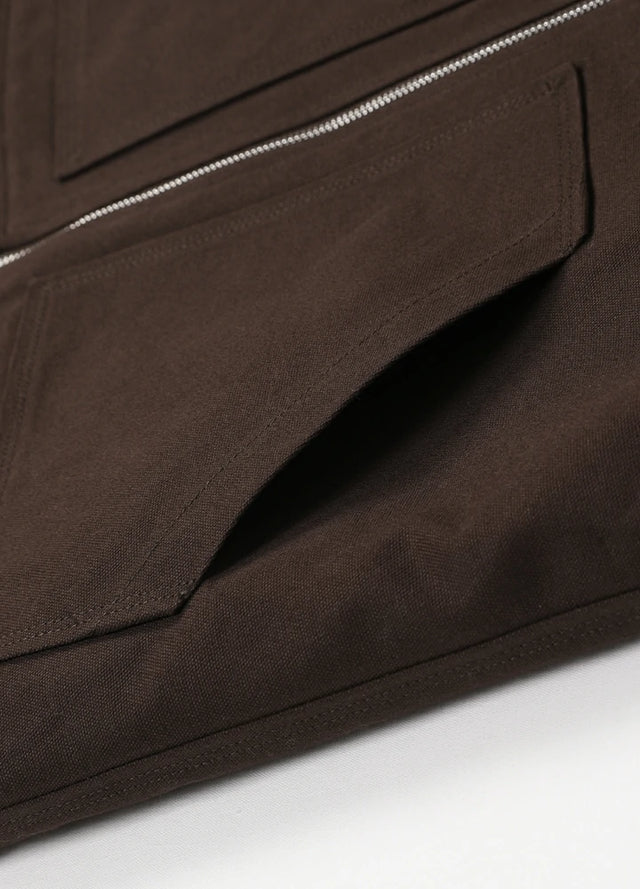Close-up of the hand pocket of a coffee men's zip closure sherpa lined vest