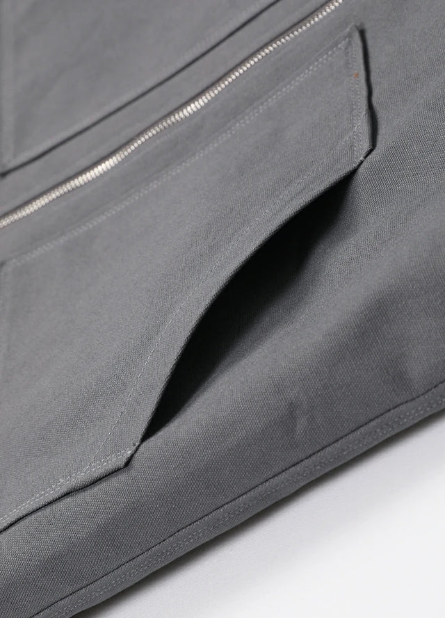 Close-up of the hand pocket of the gray men's outdoor sherpa lined vest