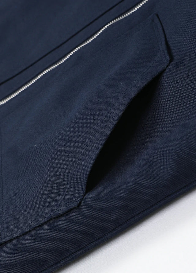 Close-up of the hand pocket of the navy men's sherpa lined canvas work vest