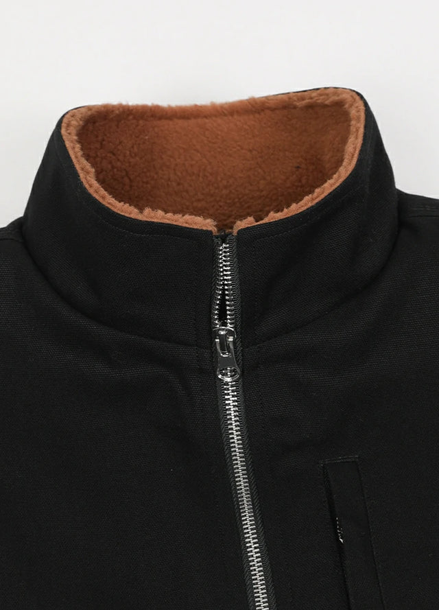 Close-up of the lapel of the black men's sherpa lined canvas vest