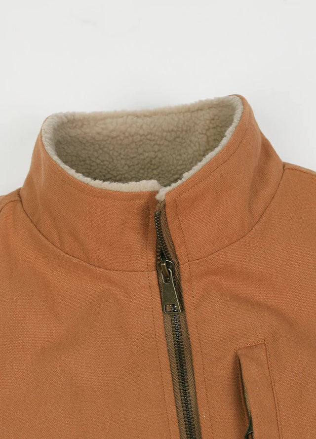 Close-up of the lapel of the brown men's durable sherpa lined canvas vest