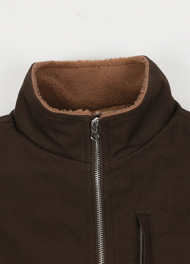 Close-up of the lapel of the coffee men's zip closure sherpa lined vest