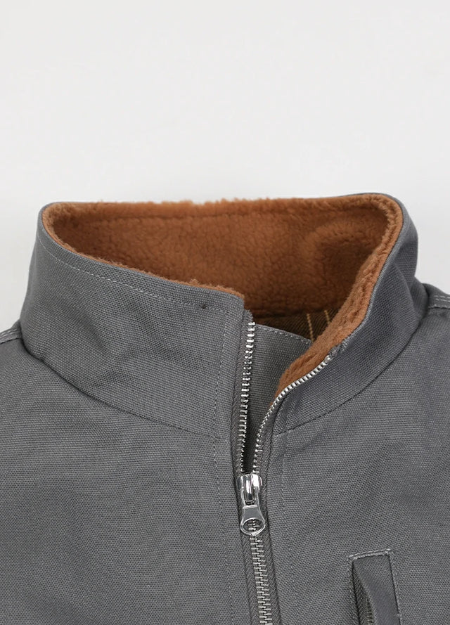 Close-up of the lapel of the gray men's outdoor sherpa lined vest