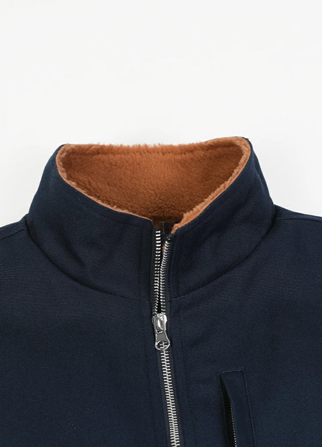 Close-up of the lapel of the navy men's sherpa lined canvas work vest