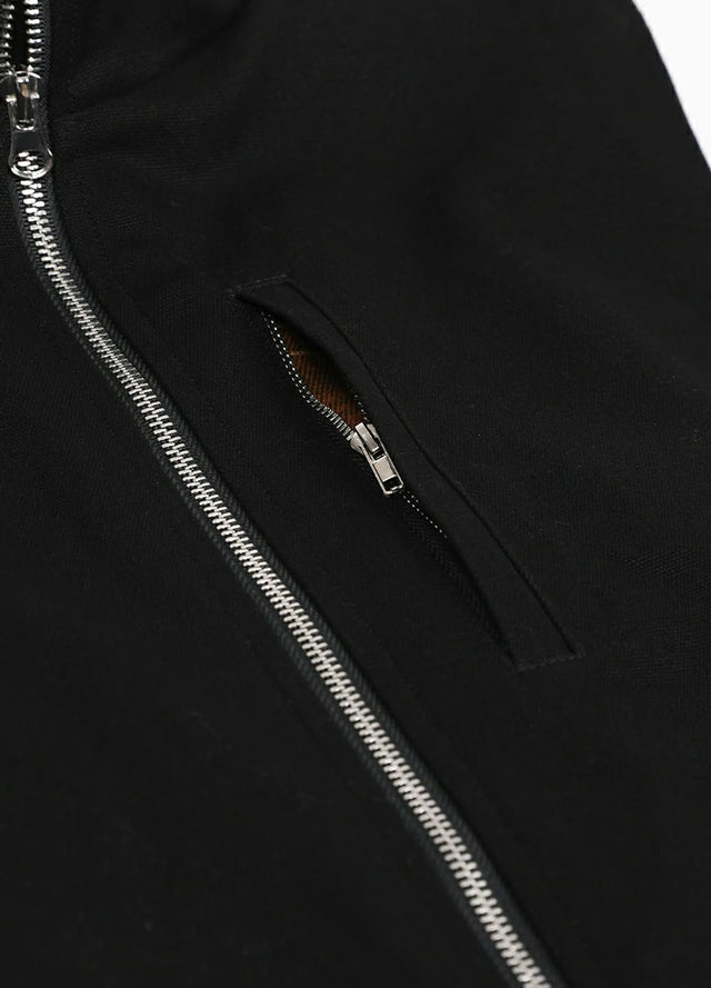 Detailed view of the pocket of the black men's sherpa lined canvas vest