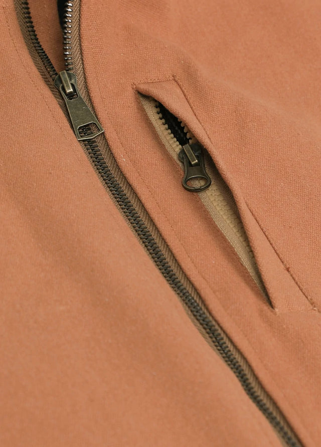 Detailed view of the pocket of the brown men's durable sherpa lined canvas vest