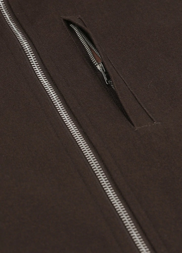 Detailed view of the pocket of the coffee men's zip closure sherpa lined vest