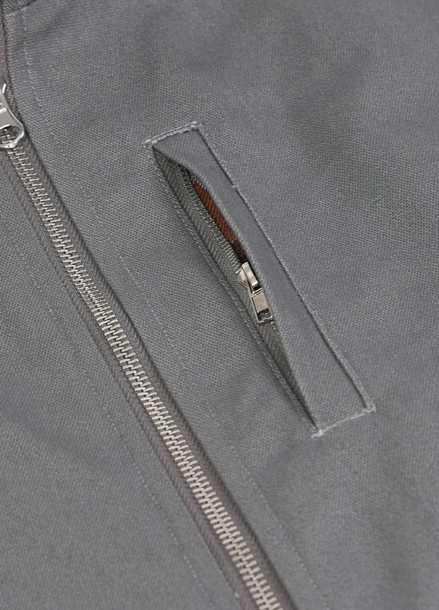 Detailed view of the pocket of the gray men's outdoor sherpa lined vest