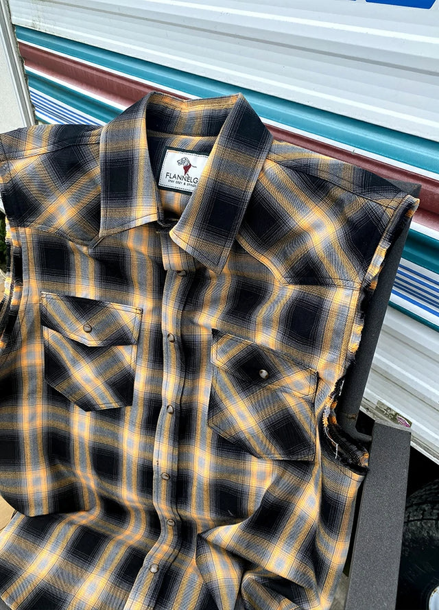 Close up of a men's orange snap button pearl western vest placed on a chair