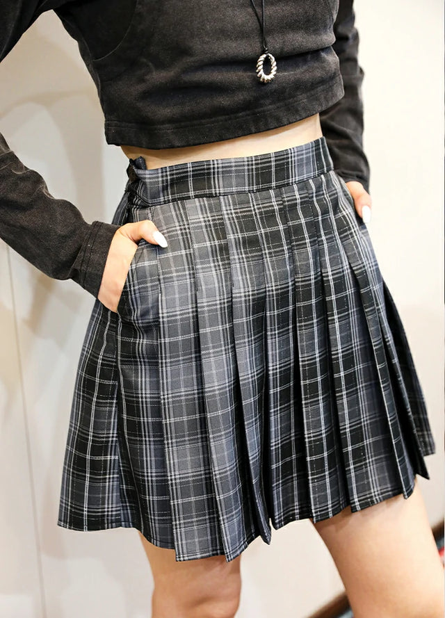 Side view of women in a elastic waist black and gray pleated skirt