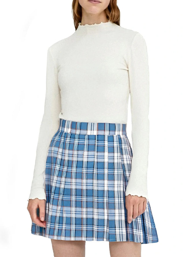 A woman in a high-waisted blue white plaid pleated mini skirt