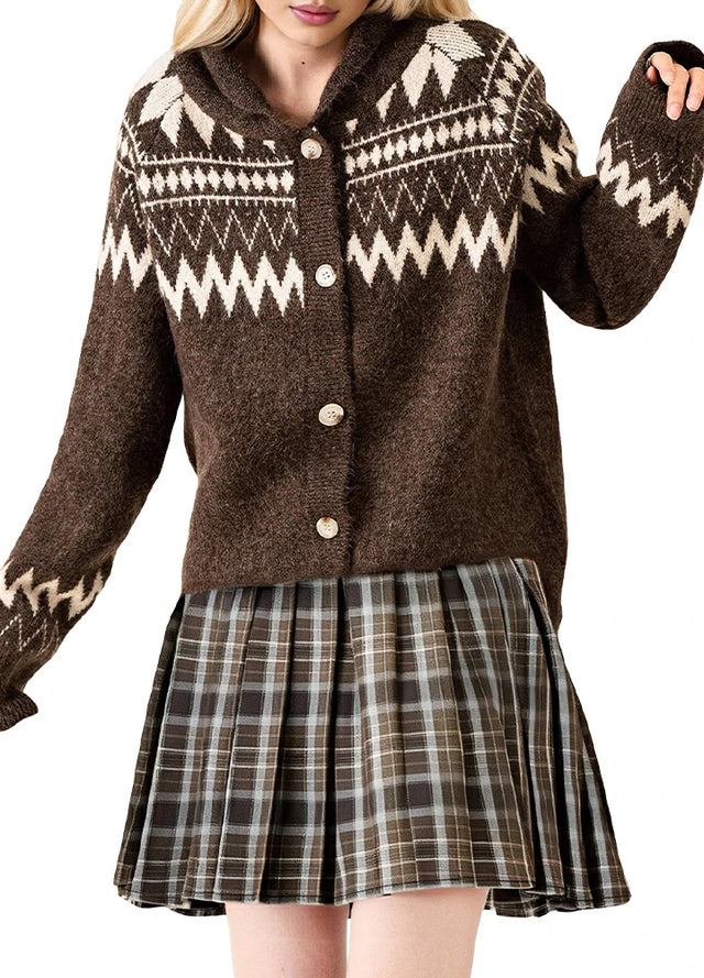 A woman in a high-waisted chocolate brown plaid pleated mini skirt