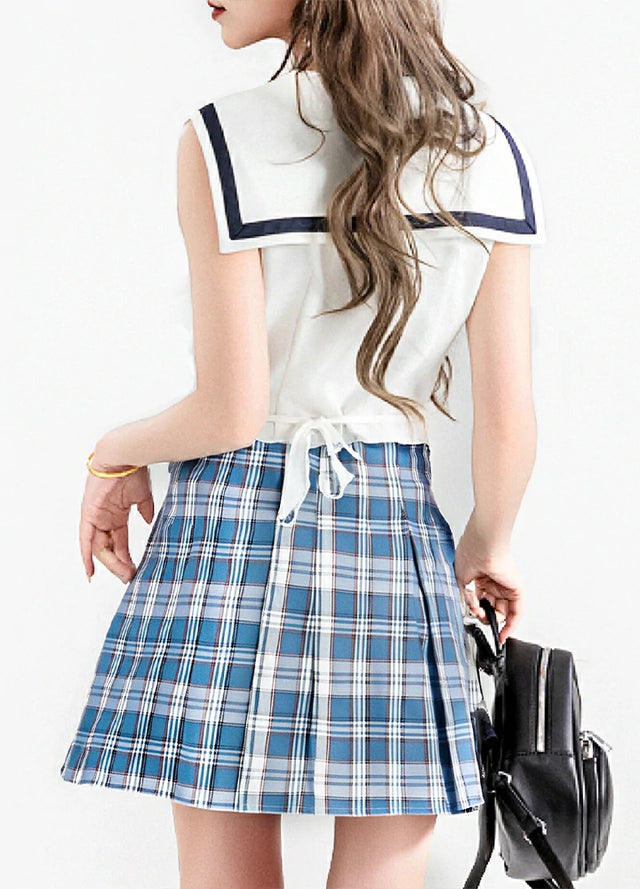 Back view of a women in a elastic waist blue white pleated skirt