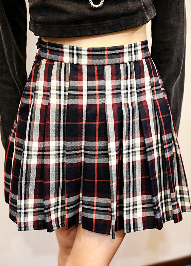 Side view of women in a elastic waist navy burgundy pleated skirt
