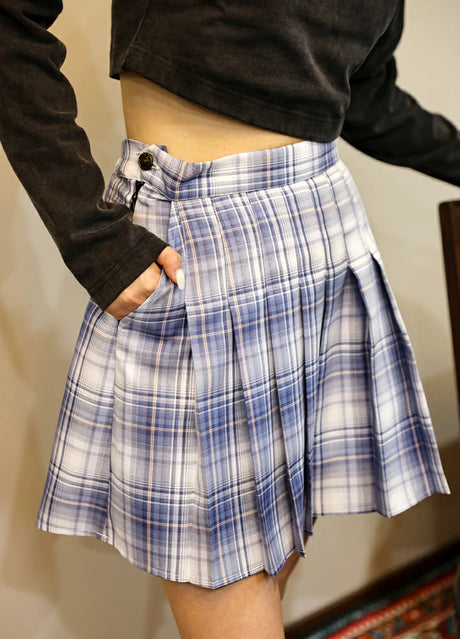 Side view of women in a elastic waist white and blue pleated skirt