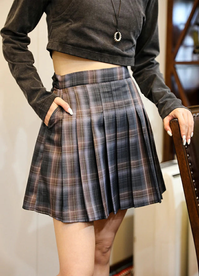 Side view of women in a elastic waist gray pink pleated skirt