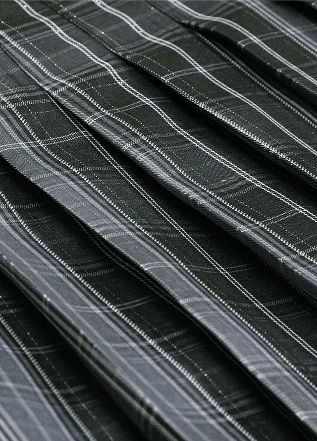 Close-up of the fabric on a women's gray plaid elastic waist pleated skirt
