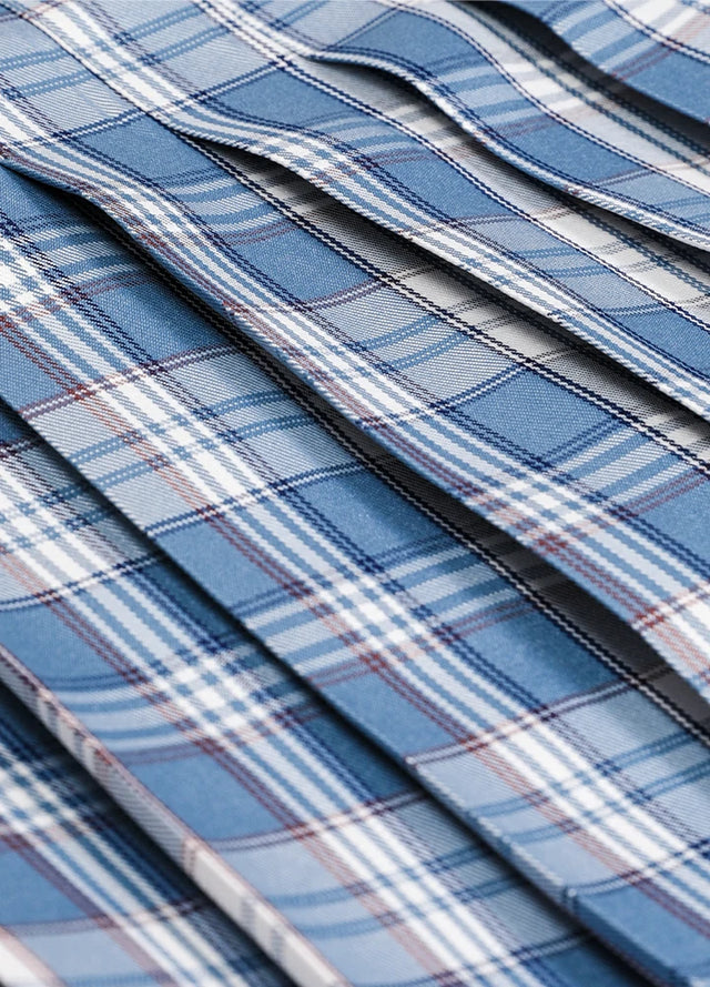 Close-up of the fabric on a women's blue white plaid elastic waist pleated skirt