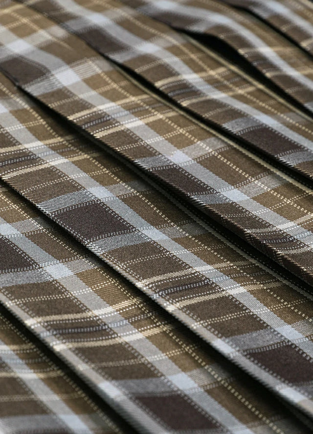 Close-up of the fabric on a women's chocolate plaid elastic waist pleated skirt