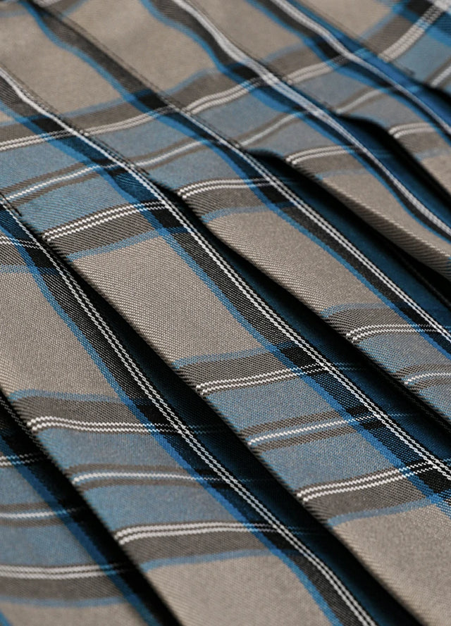 Close-up of the fabric on a women's blue gray plaid elastic waist pleated skirt