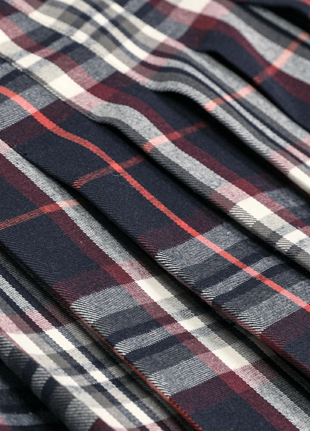Close-up of the fabric on a women's navy burgundy plaid elastic waist pleated skirt