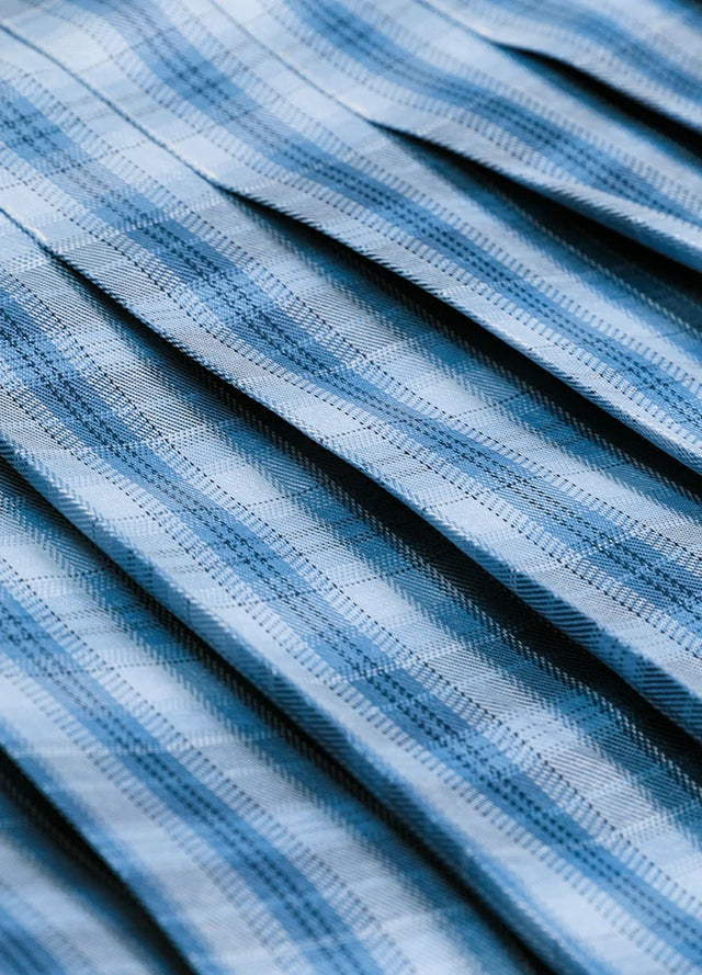 Close-up of the fabric on a women's royal blue plaid elastic waist pleated skirt