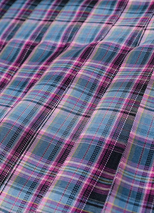Close-up of the fabric on a women's purple blue plaid elastic waist pleated skirt